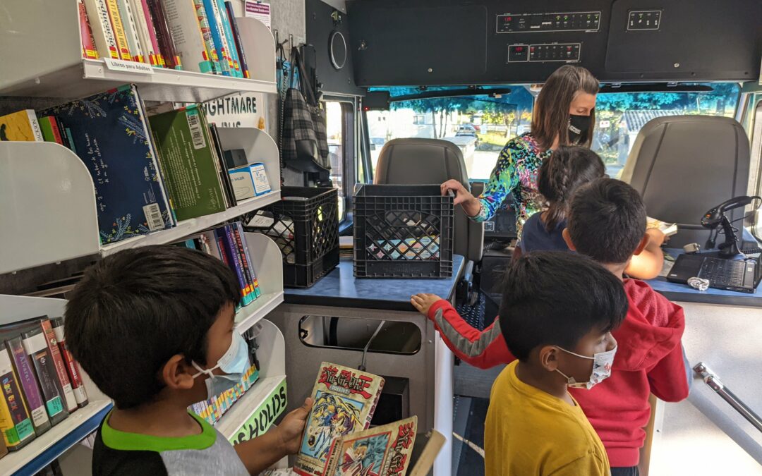 Kids checking out Dream Bus materials