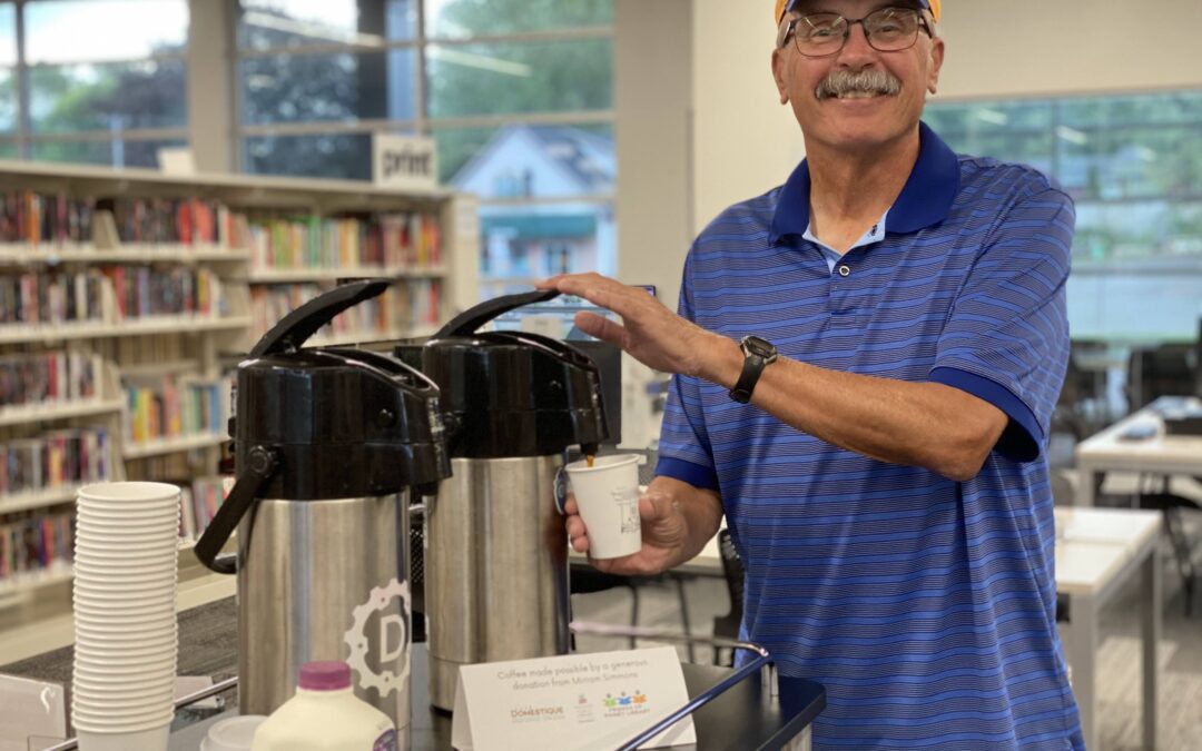 Man dispensing free coffee at Pinney Library