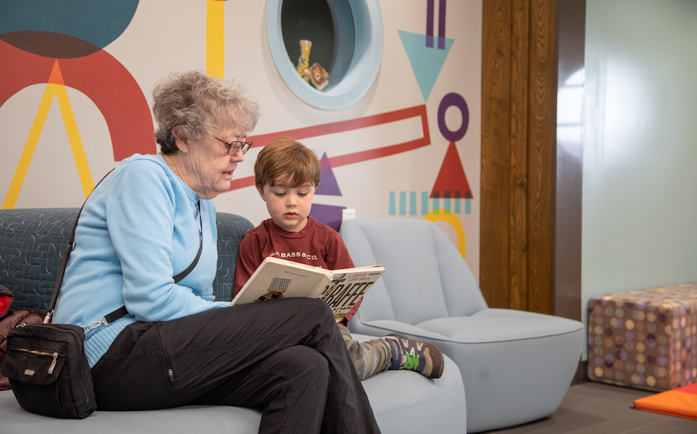 Grandmother and grandchild reading at Pinney Library
