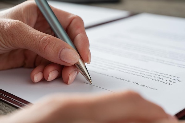 Hand writing up a trust agreement