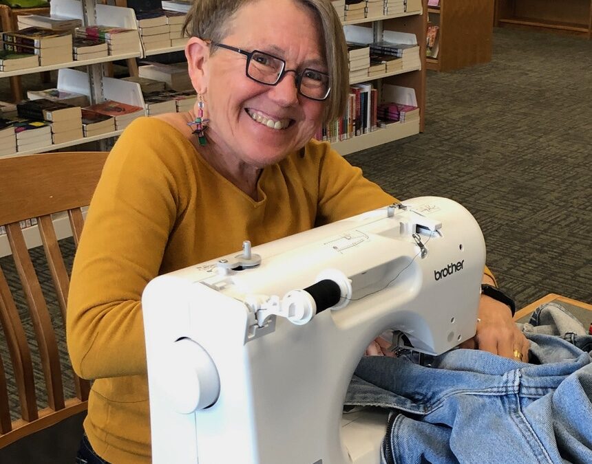 Bird Ross sewing on machine at Madison Public Library