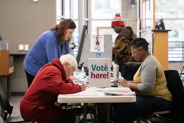 Woman registering two other women to vote at Alicia Ashman Library