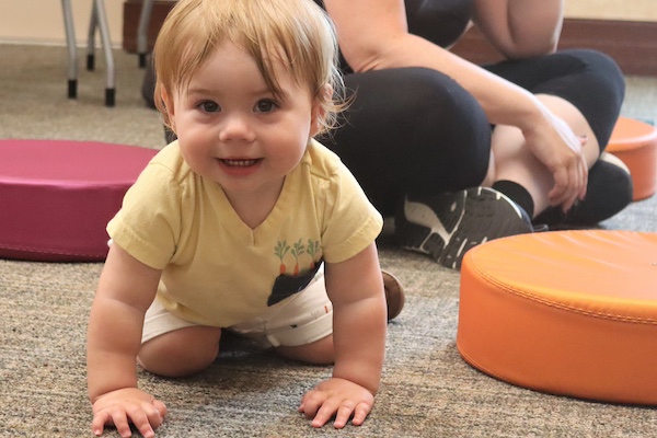 Toddler on hands and knees at storytime