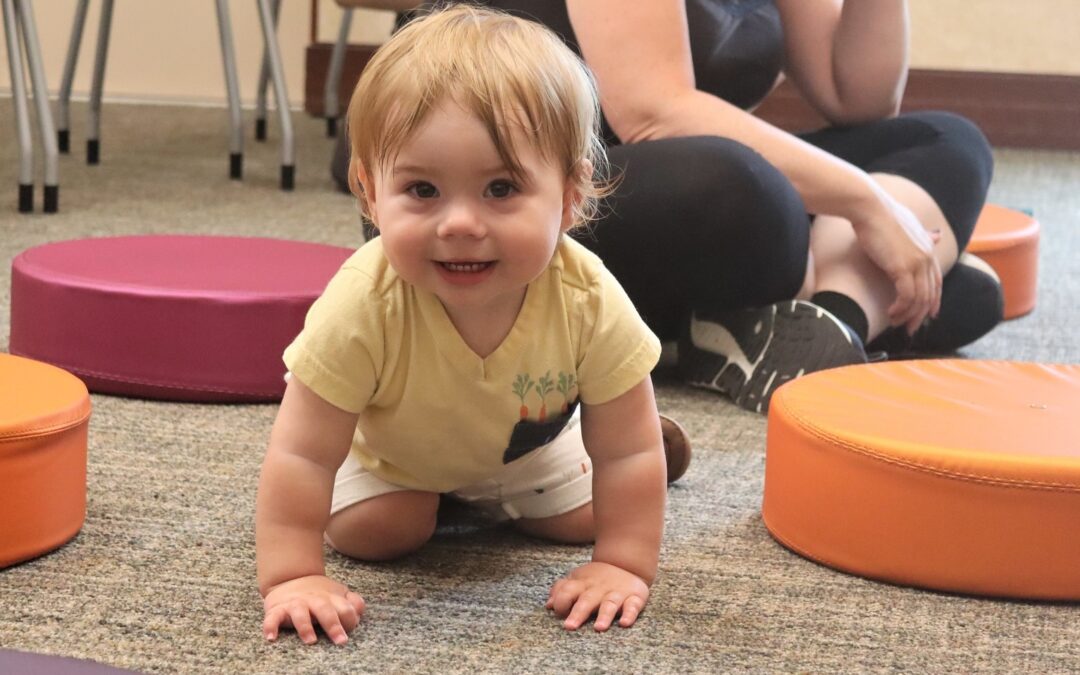 Toddler on hands and knees at Madison Public Library storytime